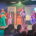 Kids in rehearsal or mid-performance during a youth musical theater production, showing emotion, teamwork, and excitement on stage.